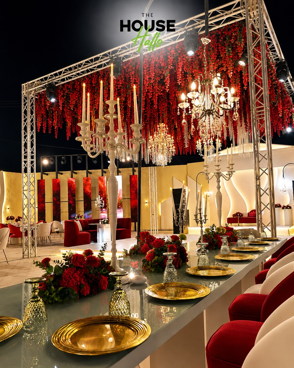 The House Halls venue with red florals, crystal chandeliers, and candelabras